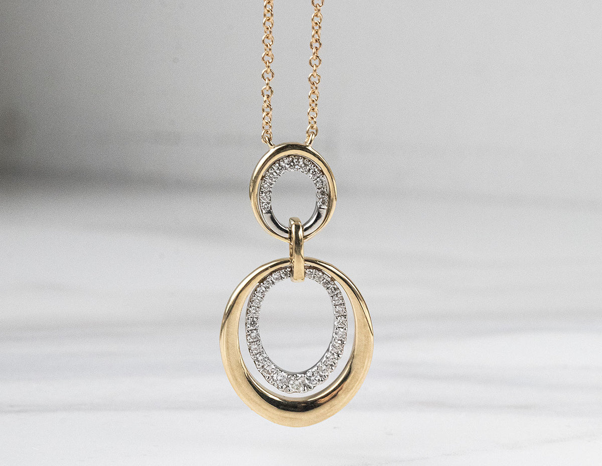 1/4ct. t.w. Diamond Oval Drop Pendant in 14K Yellow Gold and Platinum