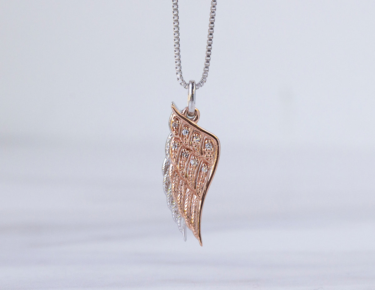 .05ct. t.w. Diamond Angel Wing Pendant in Sterling Silver and 10K Rose Gold