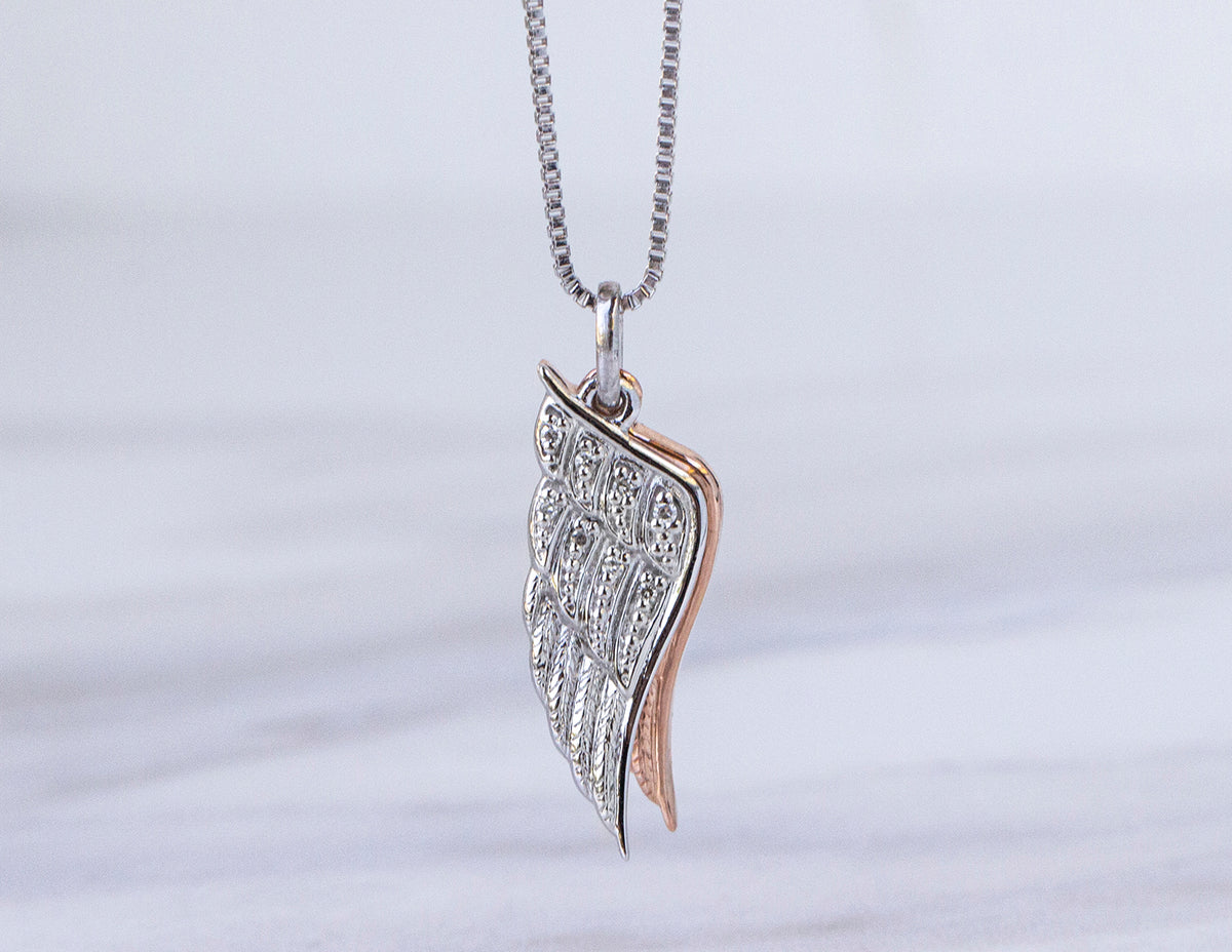 .05ct. t.w. Diamond Angel Wing Pendant in Sterling Silver and 10K Rose Gold