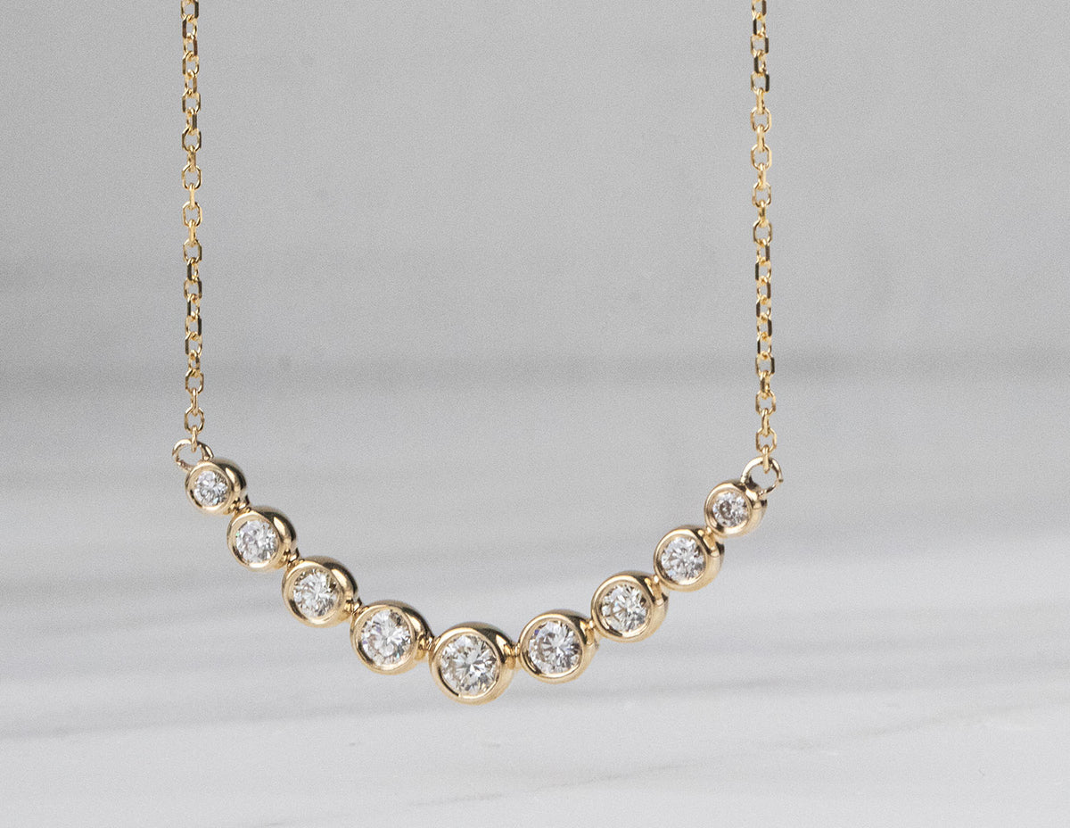 1/3ct. t.w. Diamond Graduated Curved Bar Pendant in 14K Yellow Gold