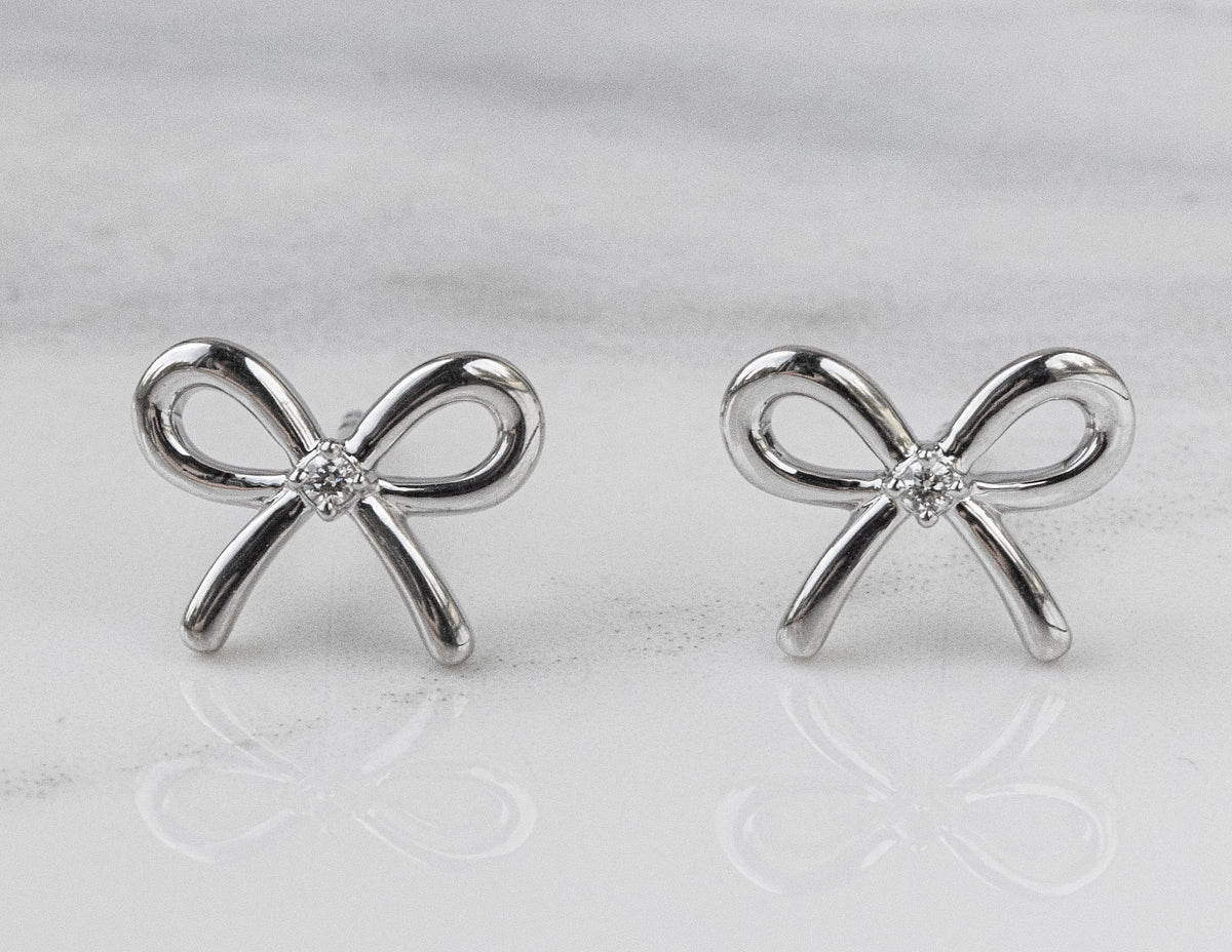 .02ct. t.w. Diamond Bow Earrings in Sterling Silver