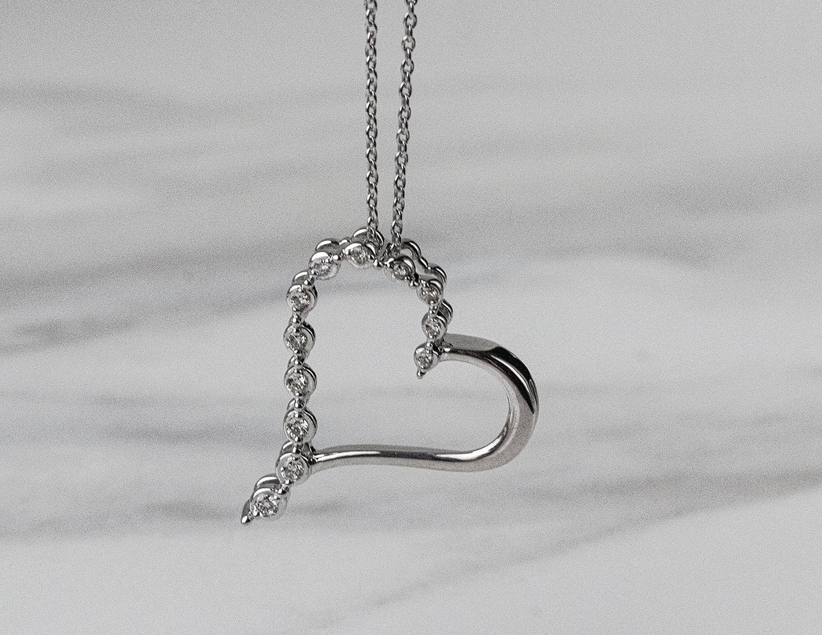 1/10ct. t.w. Diamond Journey Heart Pendant in Sterling Silver
