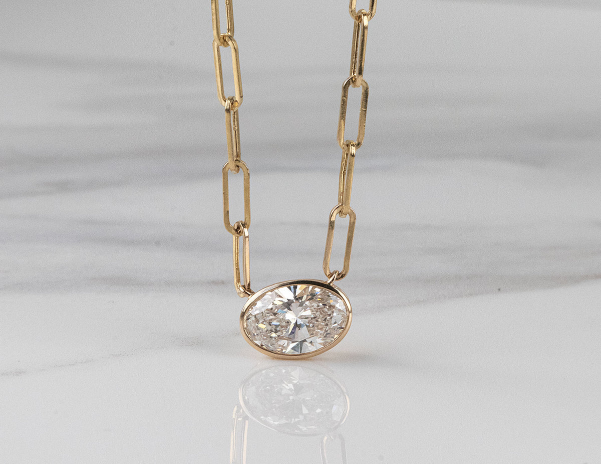 1 1/2ct. Oval Cut Newborn Lab Created Diamond Bezel Pendant in 14K Yellow Gold