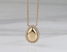 1/10ct. t.w. Pear Shape Diamond Halo Pendant in 14K Yellow Gold