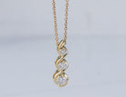 1/5ct. t.w. 3-Stone Diamond Infinity Pendant in 10K Yellow Gold