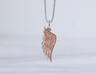 .05ct. t.w. Diamond Angel Wing Pendant in Sterling Silver and 10K Rose Gold