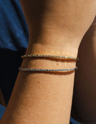 2/5ct. t.w. Round and Baguette Cut Diamond Bangle Bracelet in 14K Yellow Gold