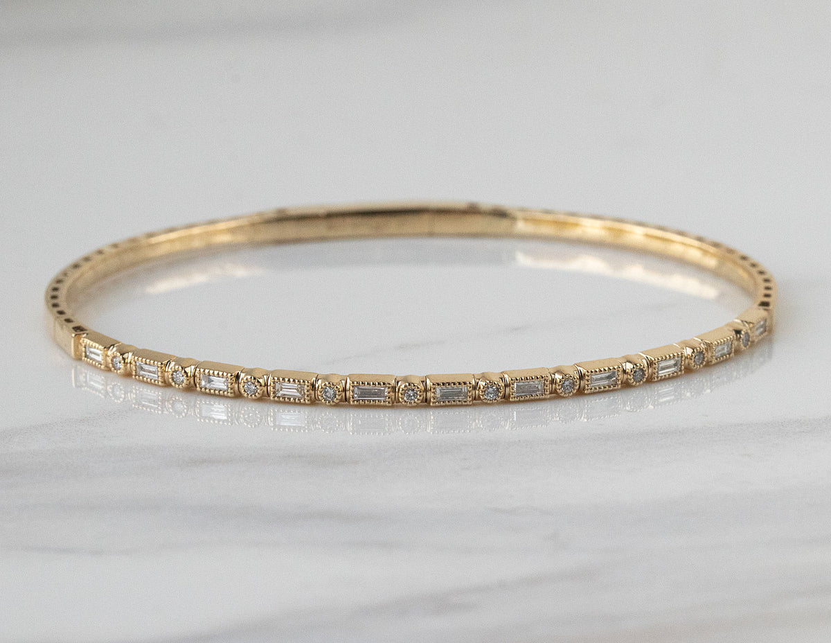 2/5ct. t.w. Round and Baguette Cut Diamond Bangle Bracelet in 14K Yellow Gold