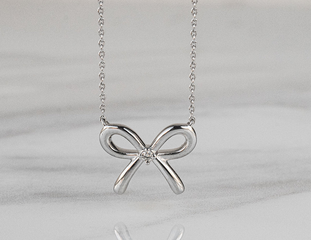 .02ct. Diamond Bow Pendant in Sterling Silver