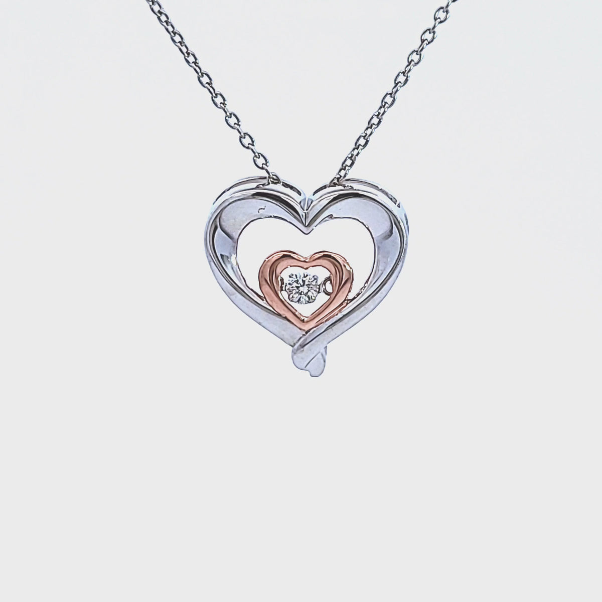 1/14ct. Diamond Dancing Hearts Pendant in Sterling Silver and 10K Rose Gold
