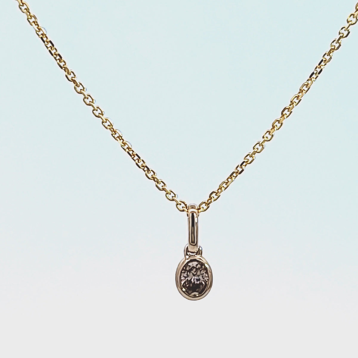 1/7ct. Brown Oval Cut Bezel Set Diamond Pendant in 14K Yellow Gold